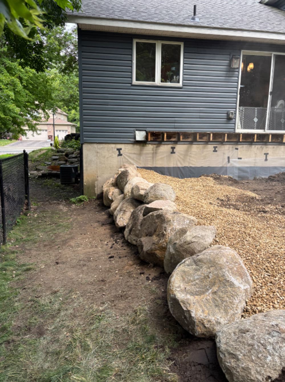 Project Boulder Retaining Wall Built Along a Home Foundation image
